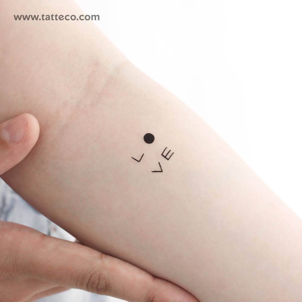 Abstract word "love" temporary tattoo located on the inner forearm.
