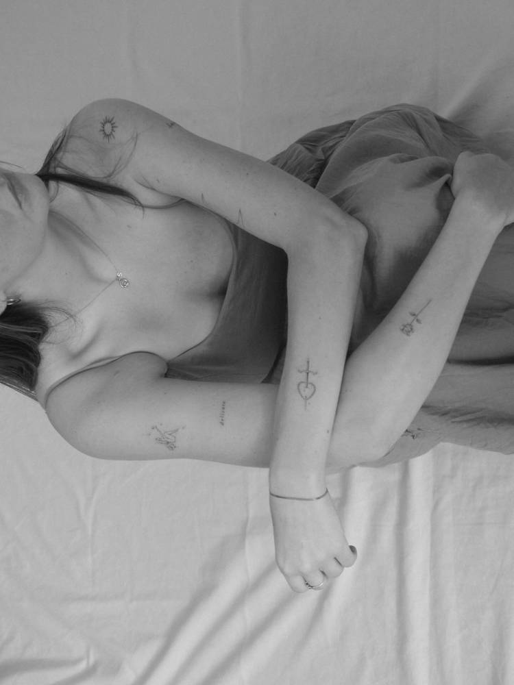 FIne line style arm composition tattoos.