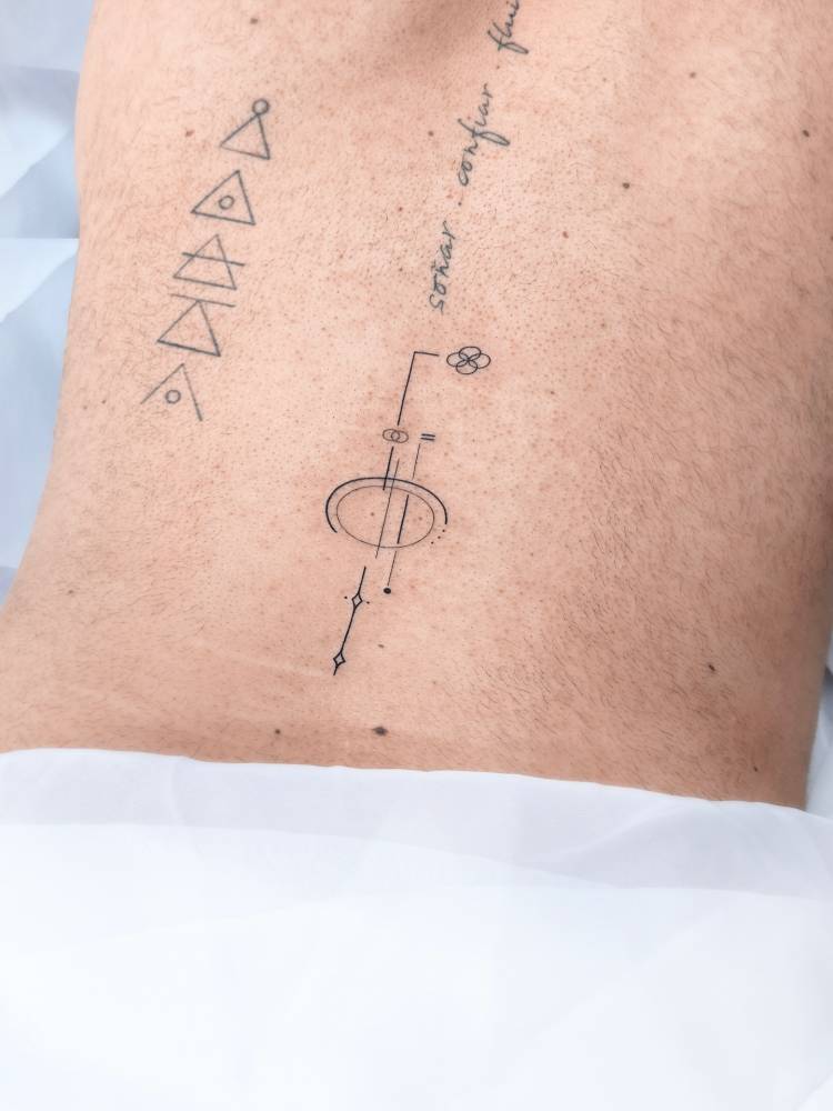 Geometric design tattooed on the lower back.