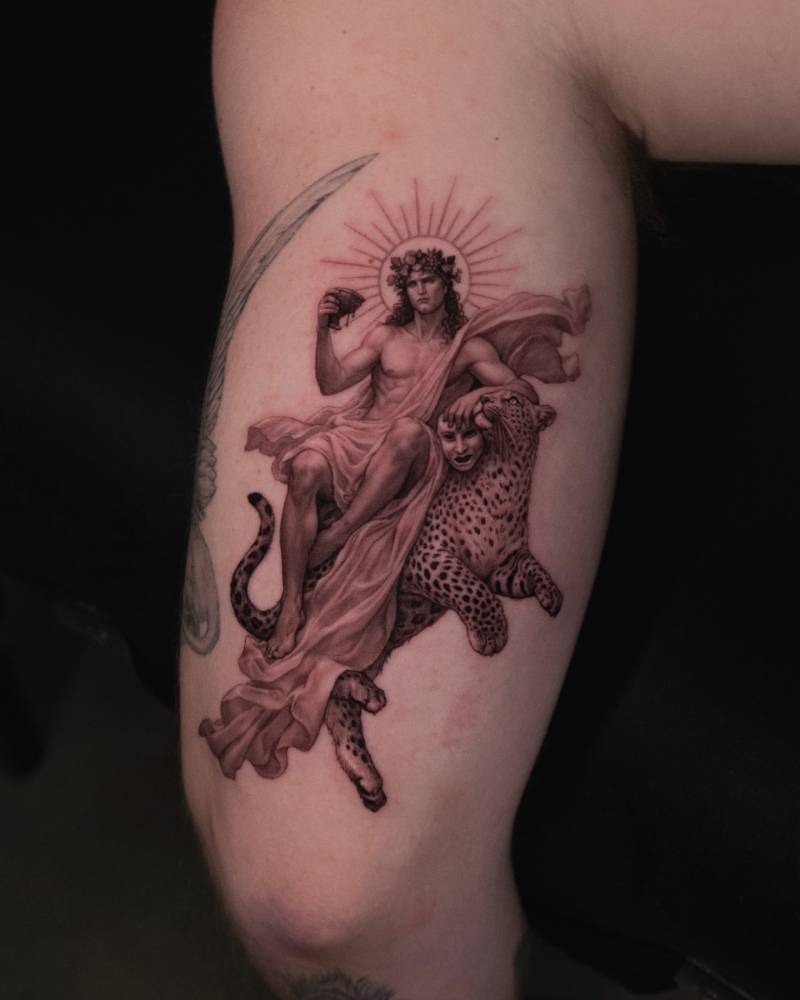 Dionysus tattoo located on the tricep, done in micro-realistic style.
