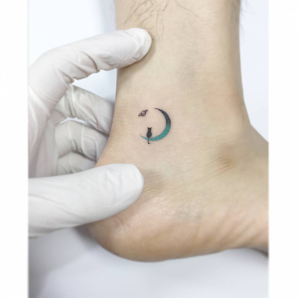 Spectrum moon and black cat tattoo located on the ankle.