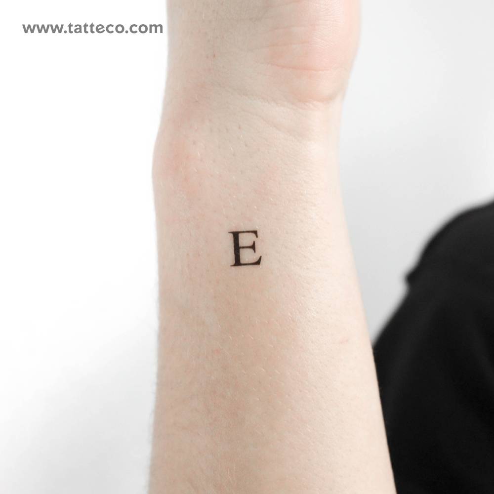 "E" serif capital letter temporary tattoo located on the wrist.