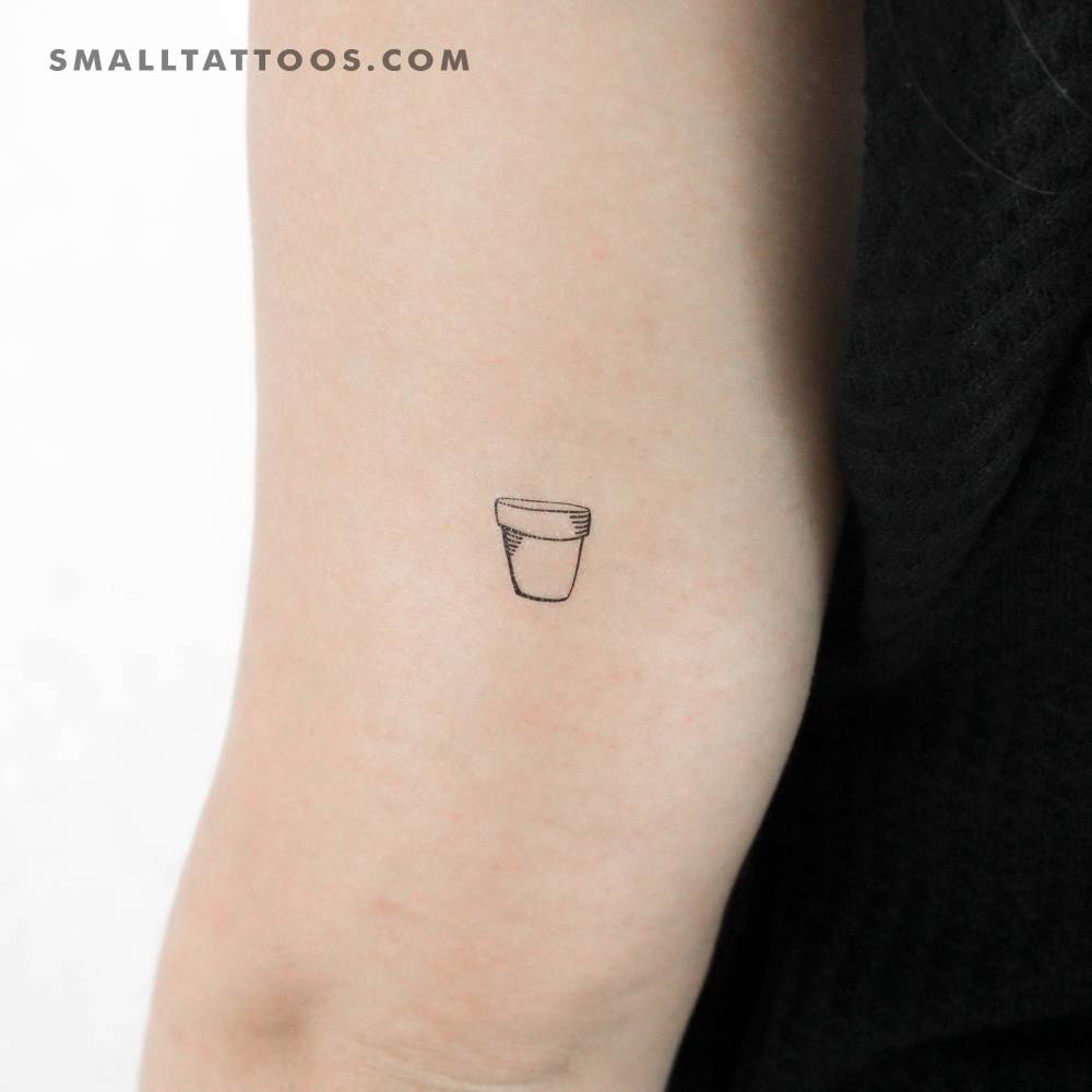 Fine line style flower pot temporary tattoo located on the tricep.