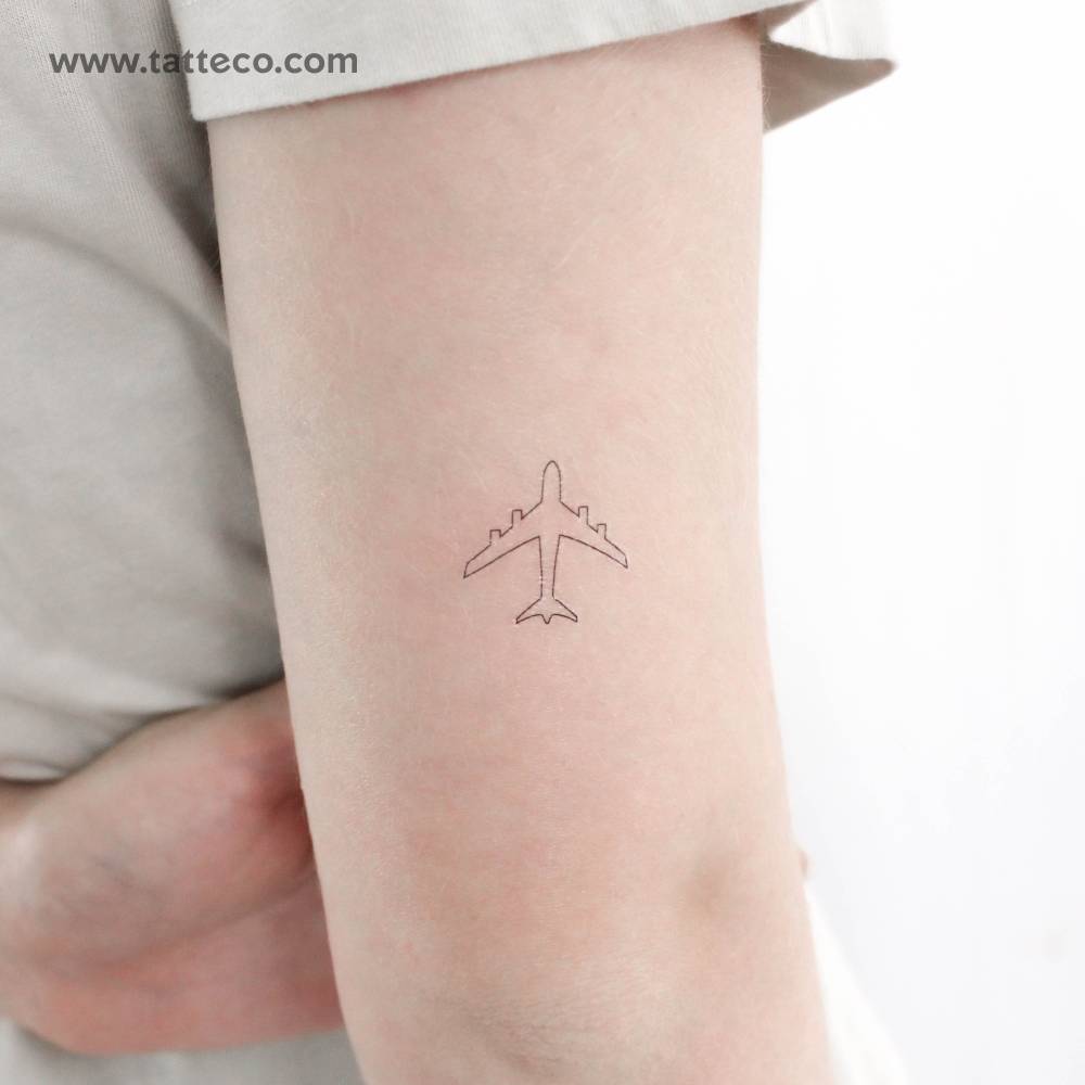 Fine line style airplane temporary tattoo located on the tricep.