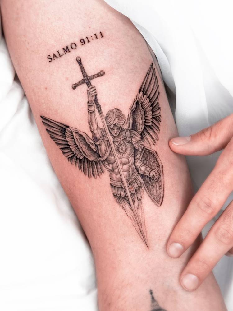 Archangel Michael tattoo located on the bicep, done in illustrative style.