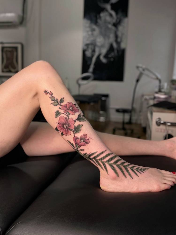 Flowers tattoo located on the shin and foot.
