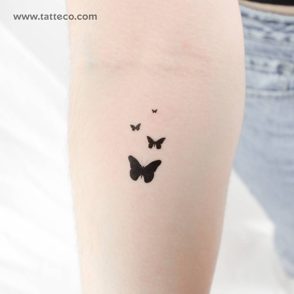 Butterfly family temporary tattoo located on the inner forearm.