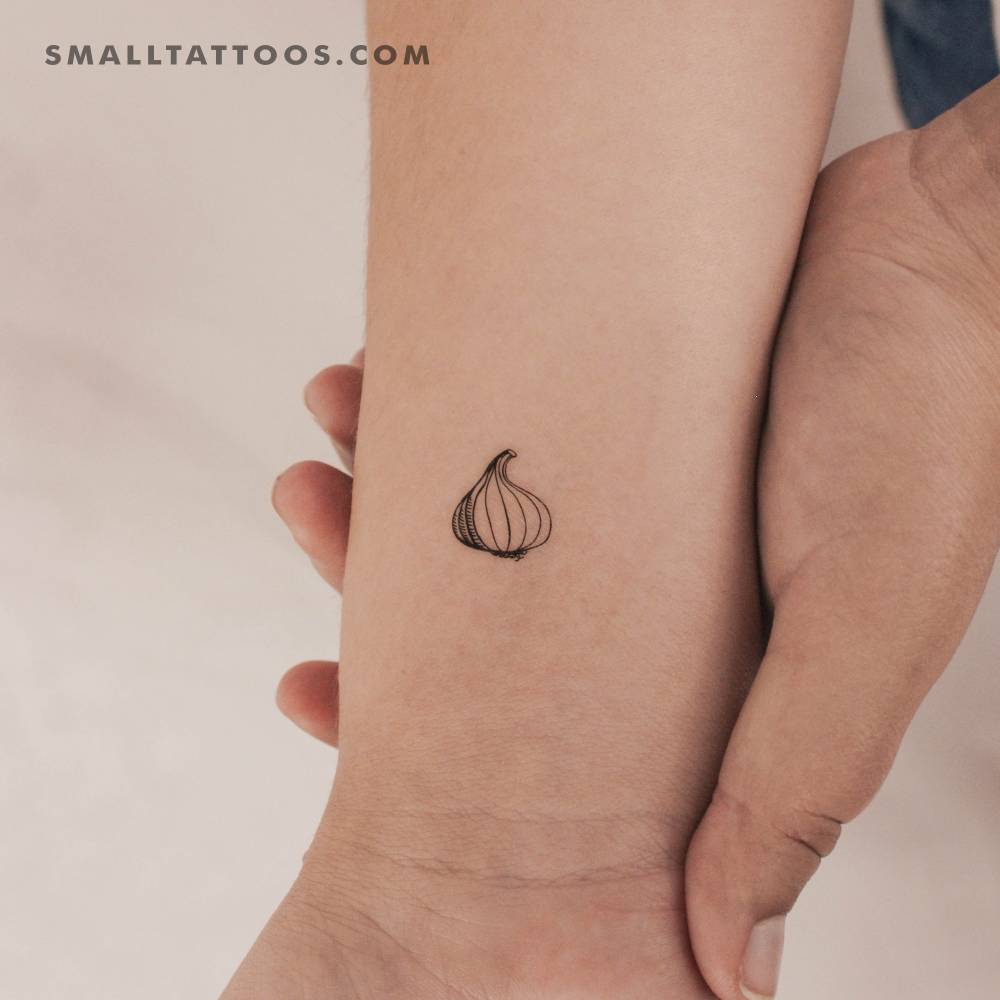 Tiny garlic temporary tattoo located on the wrist.