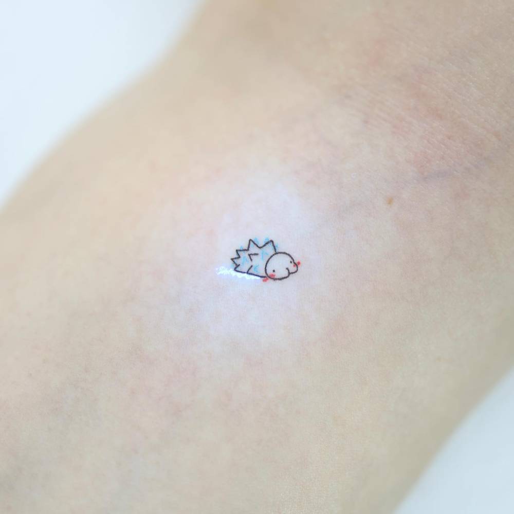 Snom tattoo in cartoon style located on the wrist.