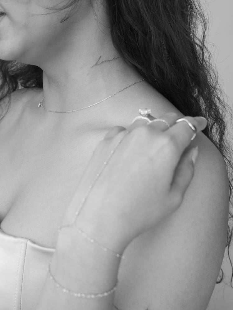 Handwritten font word "home" tattooed on the neck.