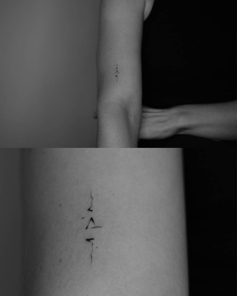 Abstract concept tattoo located on the upper arm.