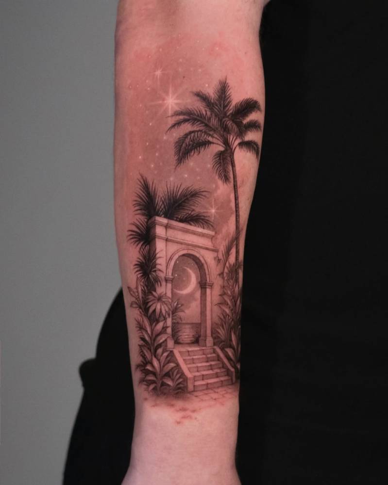 Archway on the beach tattooed on the forearm.