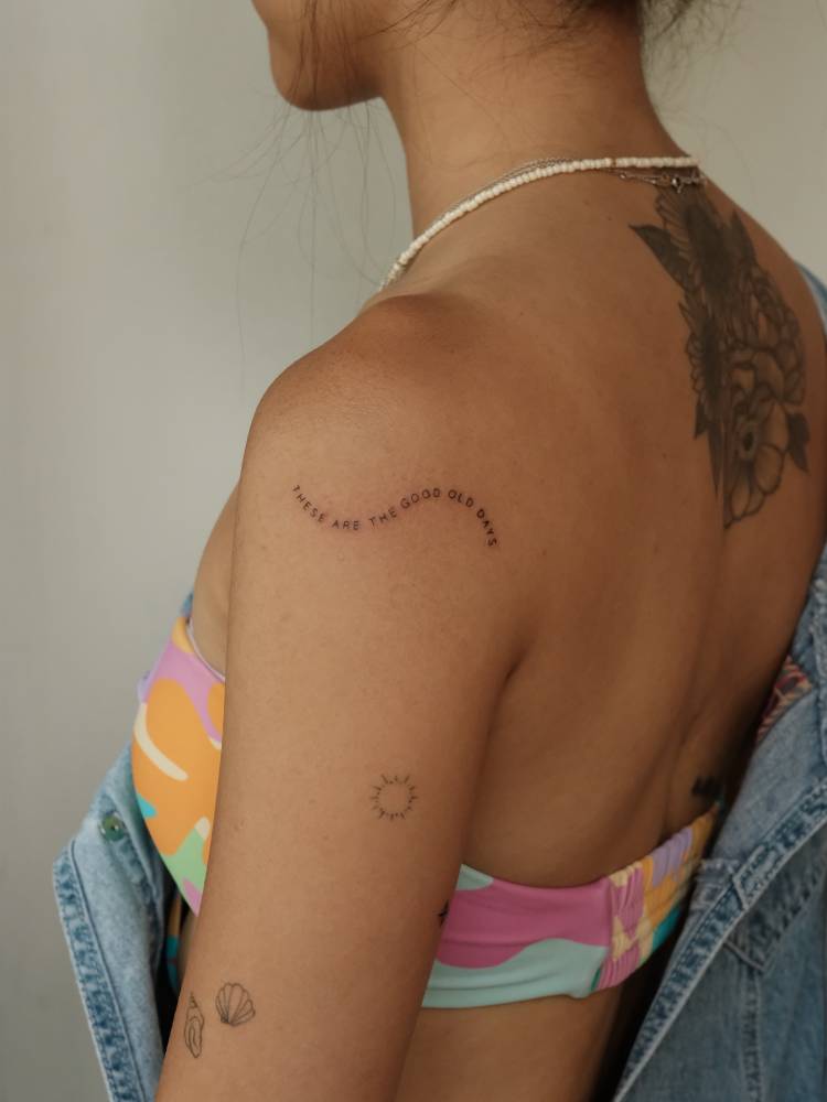 "These are the good old days" lettering tattoo located on the shoulder.