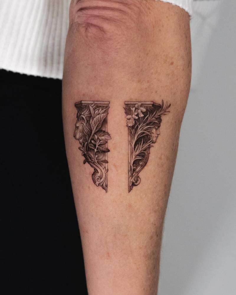 Micro-realistic style columns tattooed on the forearm.