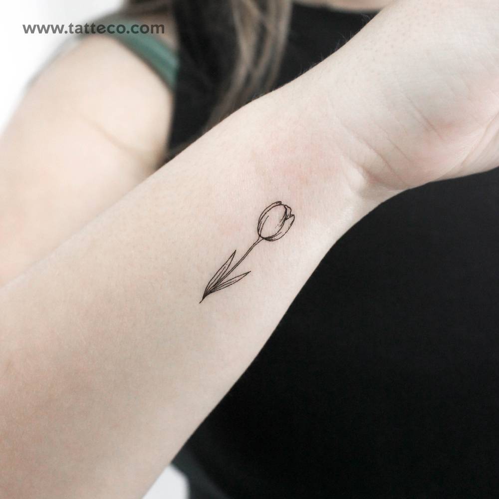 Fine line style tulip temporary tattoo located on the wrist.