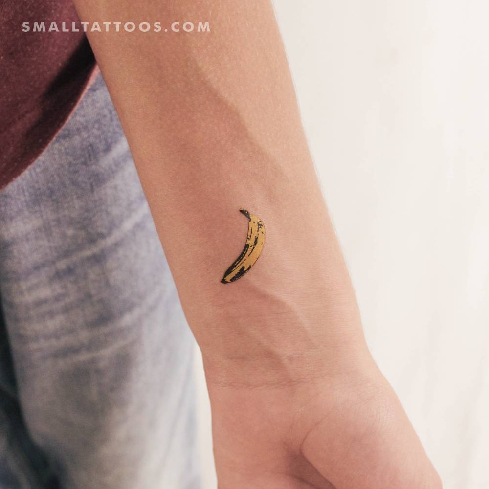 Yellow banana temporary tattoo located on the wrist.