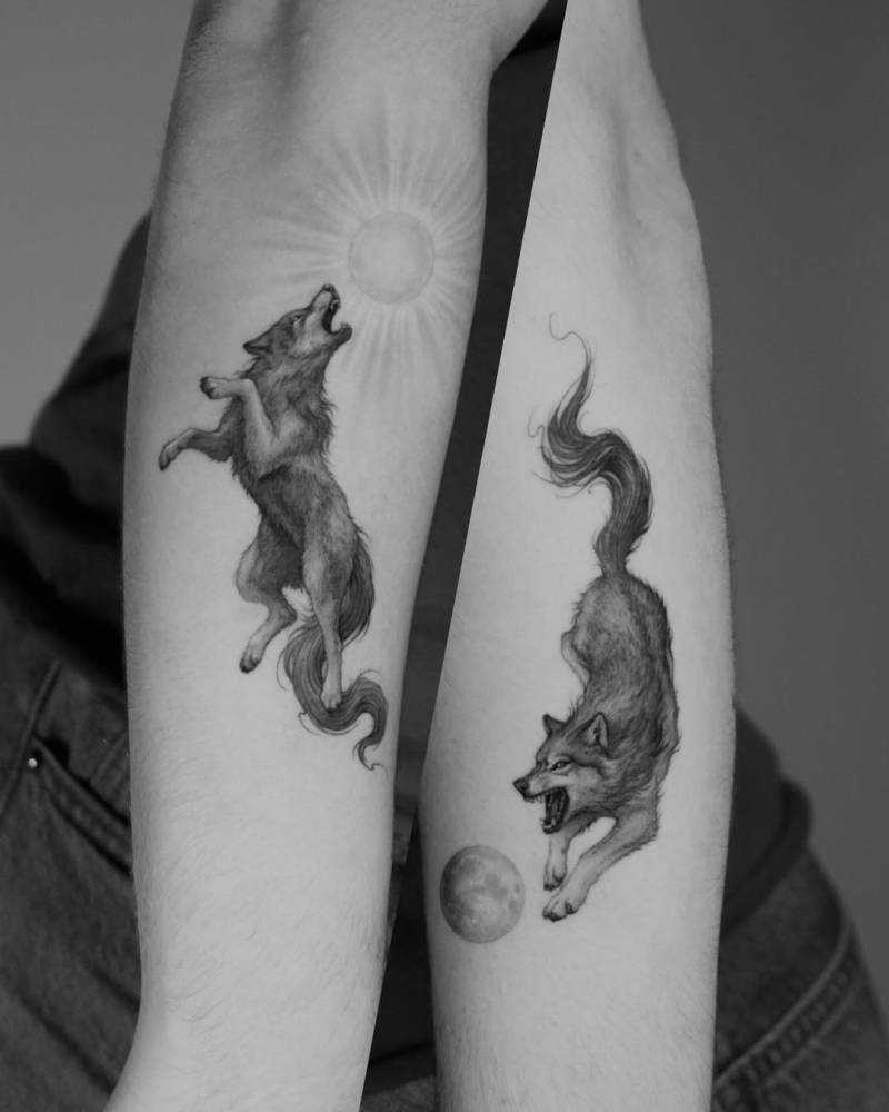 Individual matching Sköll and Hati tattoo located on the forearm.