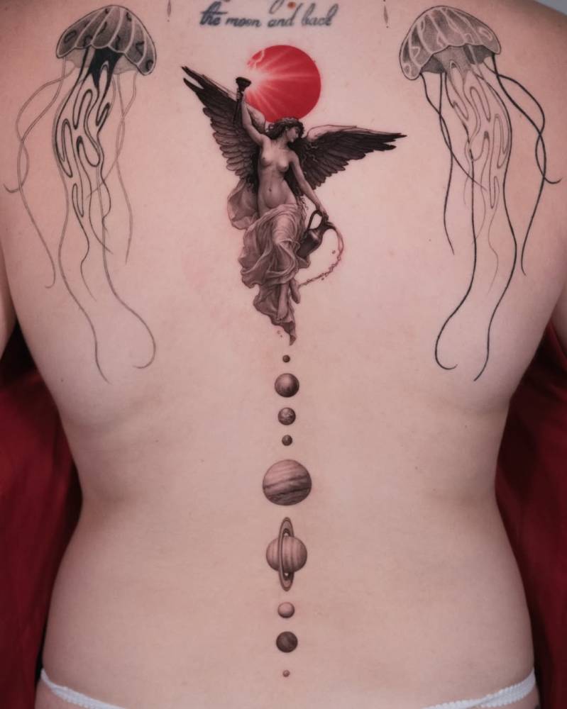 Aurora and Solar System tattoo located on the spine.