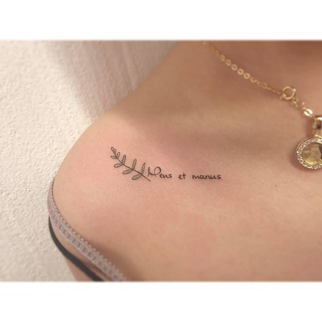 "Mens et manus" and branch tattooed on the collarbone.