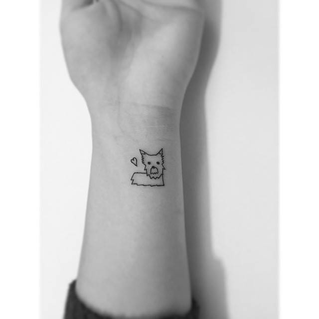 Yorkshire Terrier tattoo in minimalistic style located on the wrist.