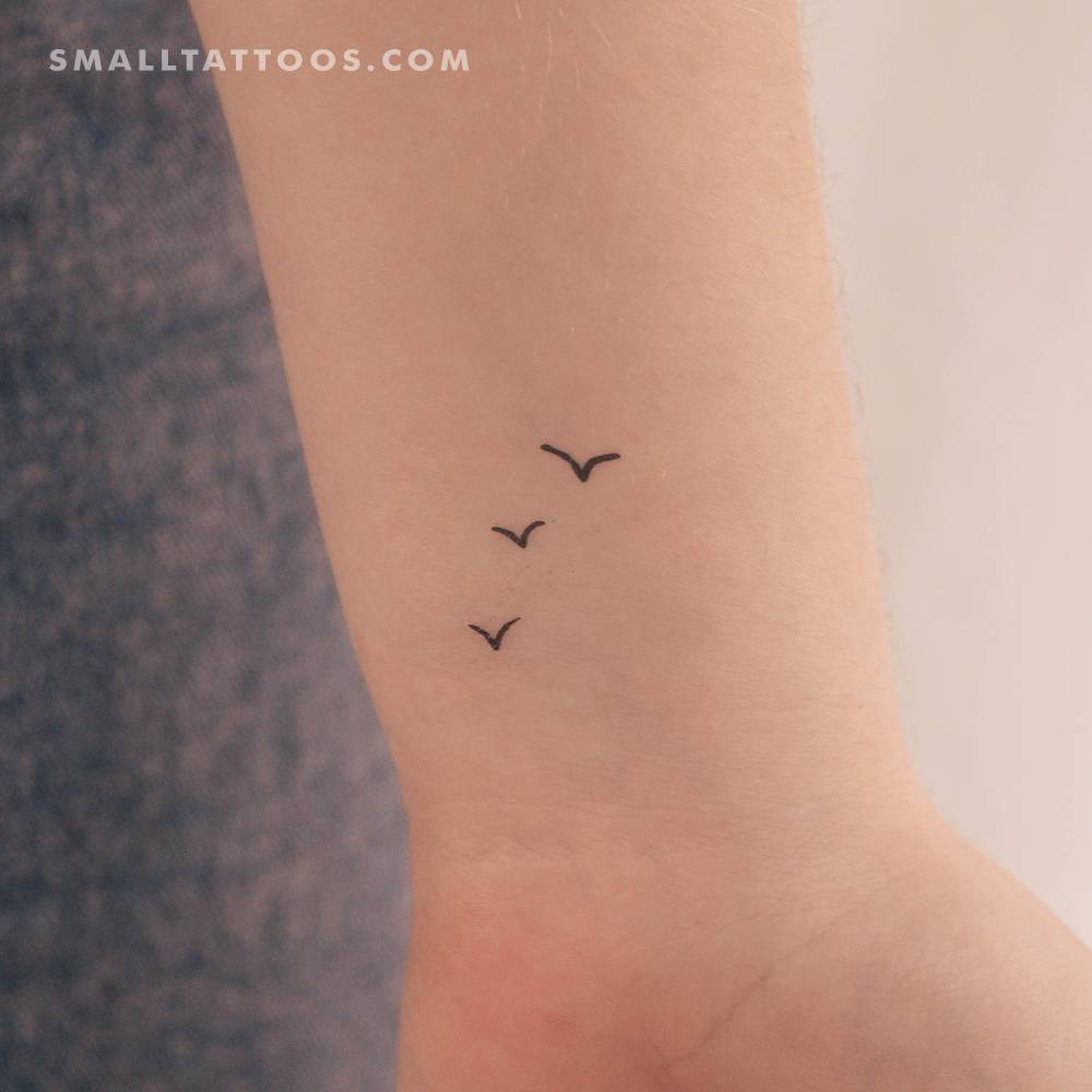Little three birds temporary tattoo placed on the wrist.