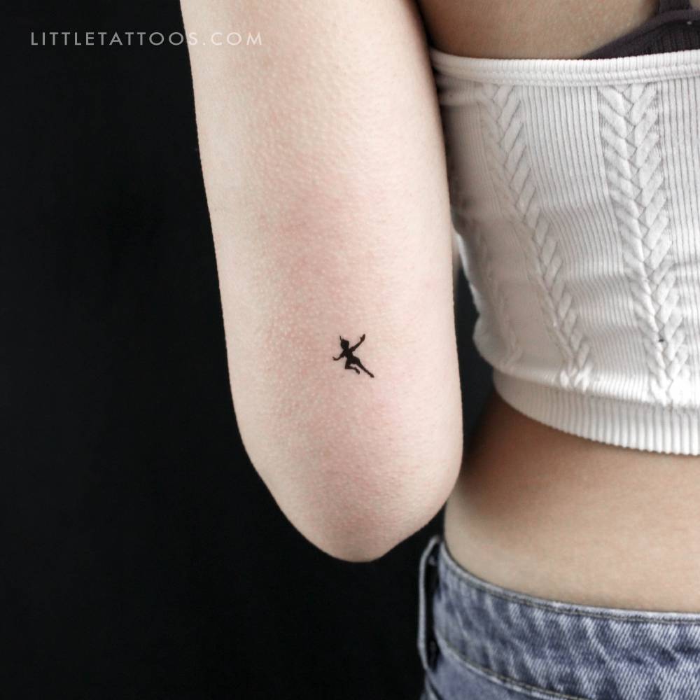 Peter Pan silhouette temporary tattoo located on the tricep.