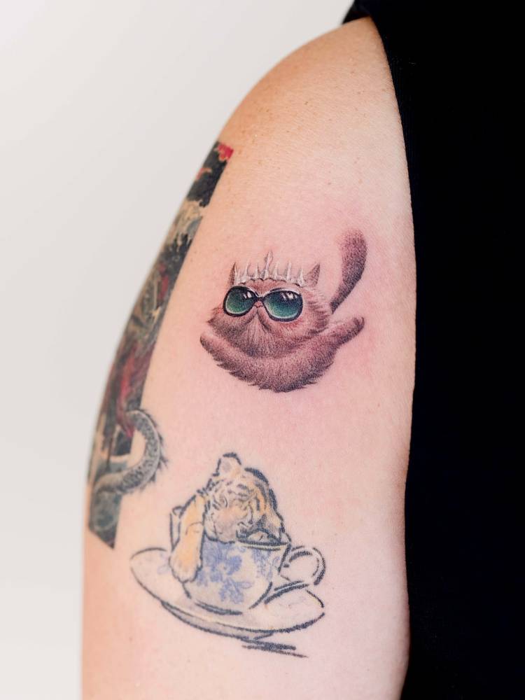Princess Donut from Dungeon Crawler Carl tattooed on the upper arm.