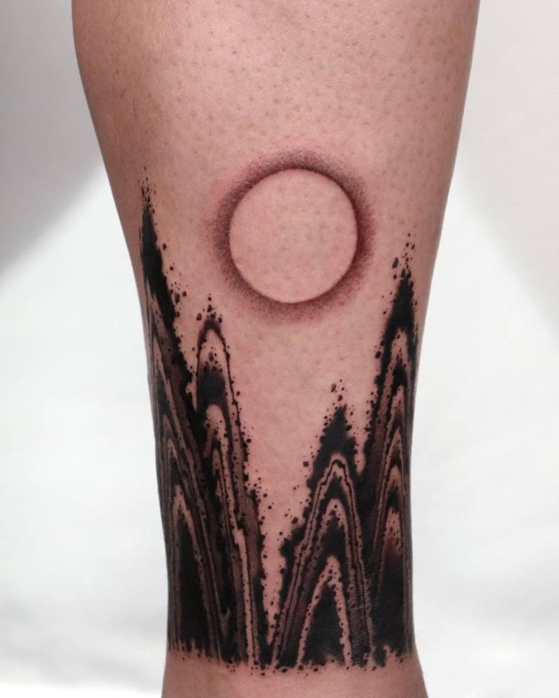 Abstract mountain flow tattoo located on the ankle.
