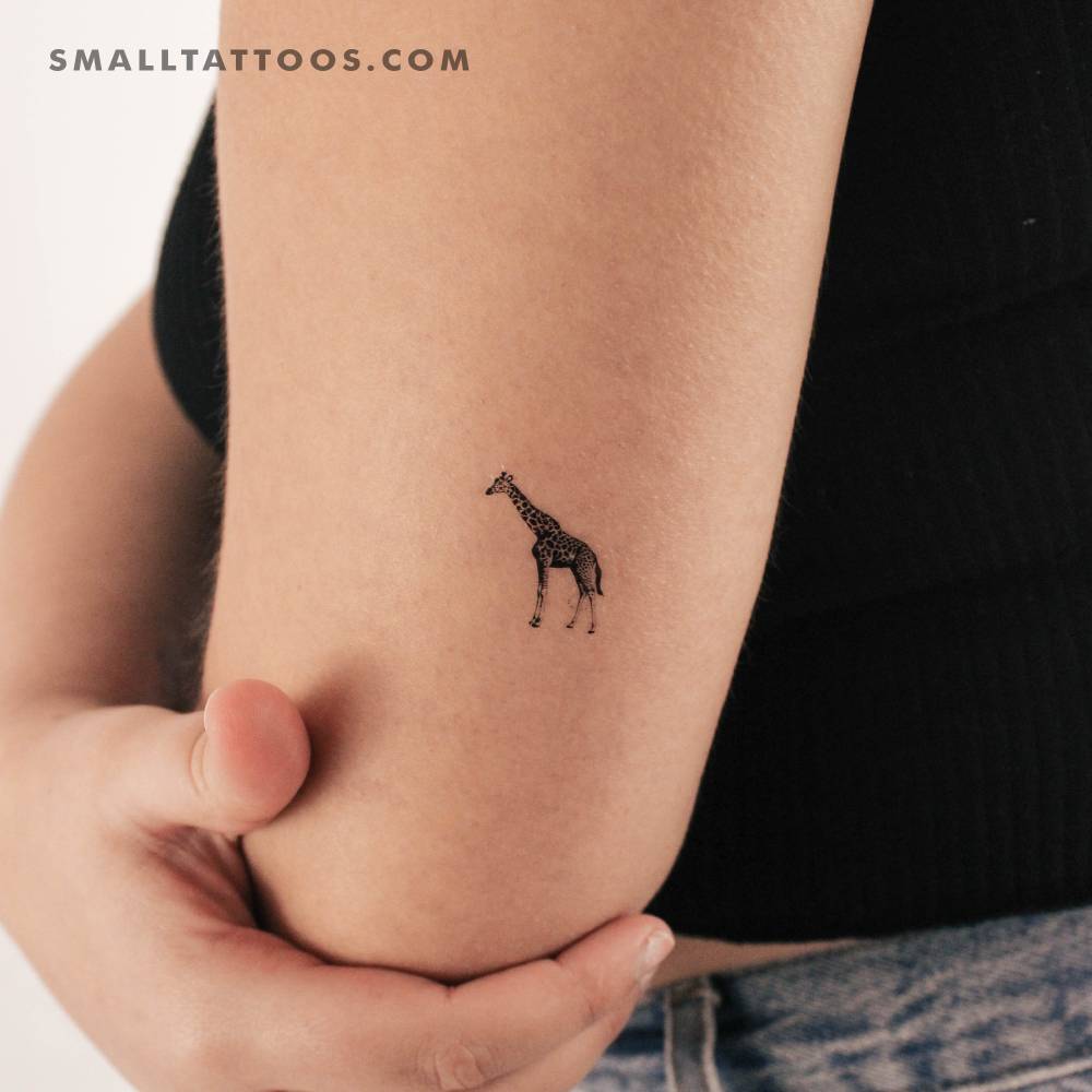 Micro-realistic style giraffe temporary tattoo located on the tricep.