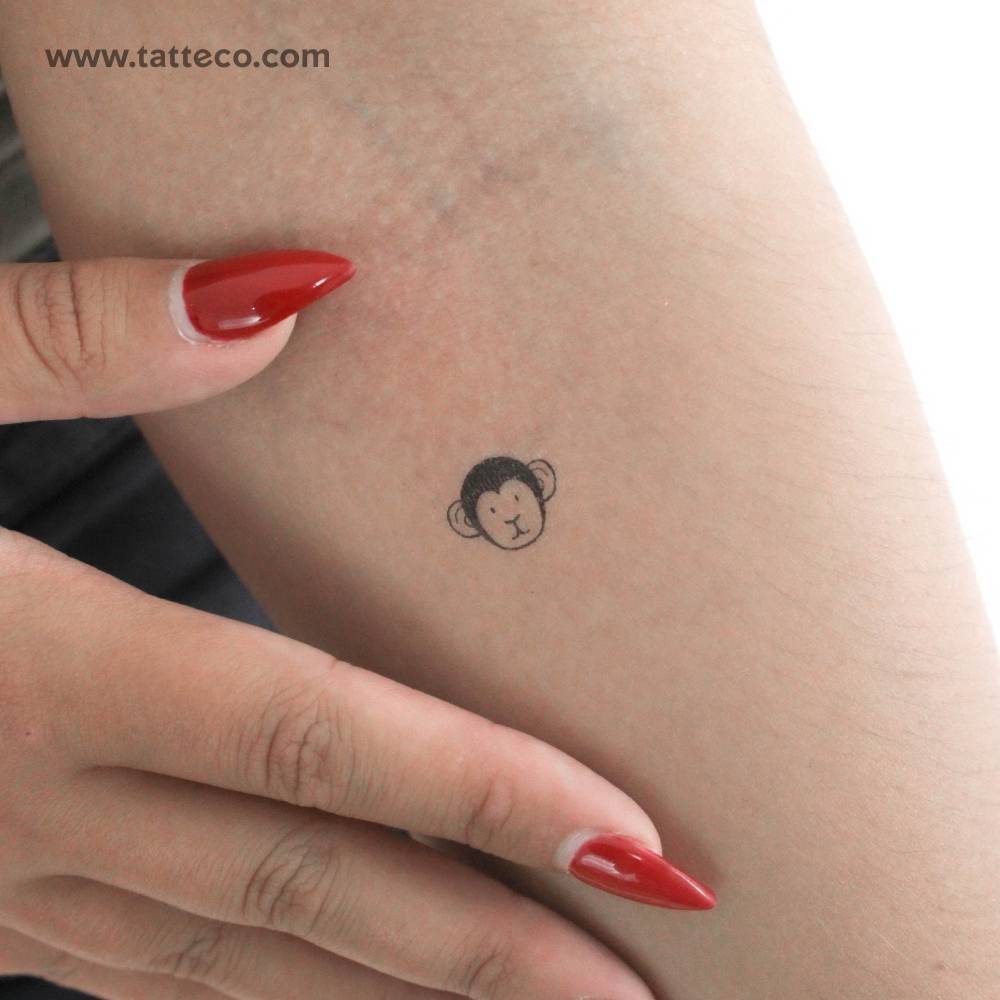 Little monkey face temporary tattoo located on the inner forearm.