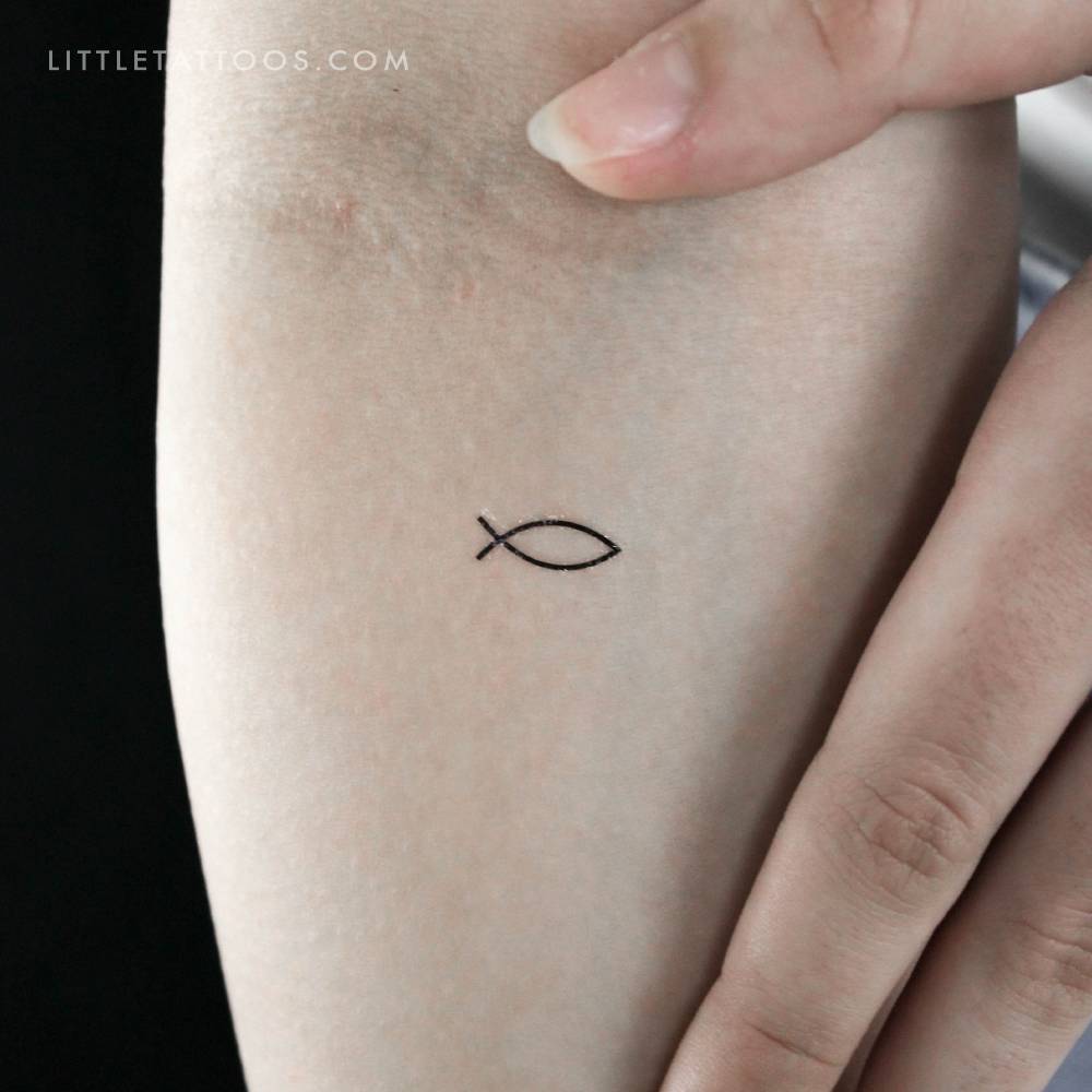 Fine line Jesus fish temporary tattoo located on the inner forearm.