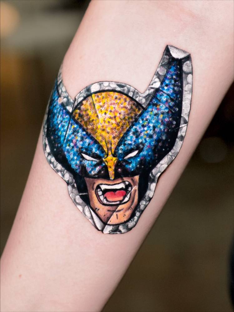 Wolverine sticker tattoo located on the inner forearm.
