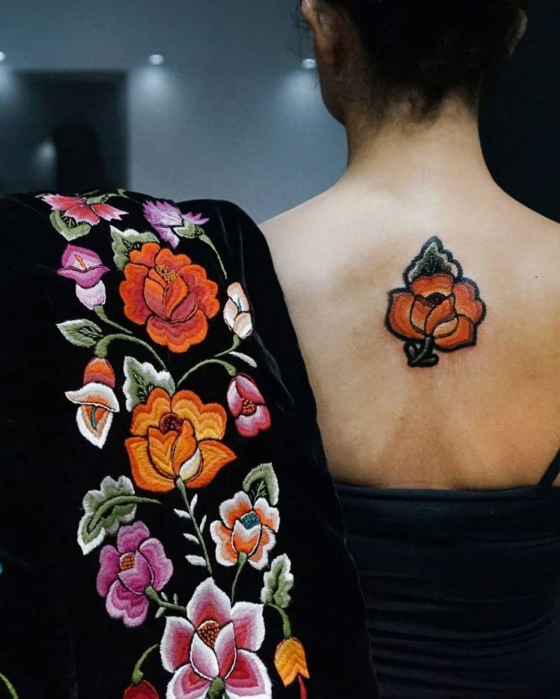Mexican embroidery tattoo located on the upper arm.