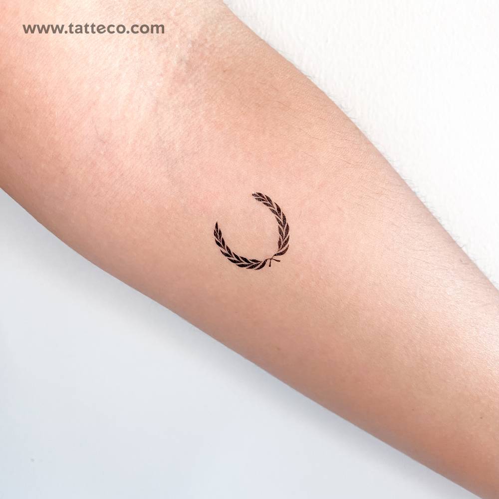 Laurel wreath temporary tattoo located on the inner forearm.