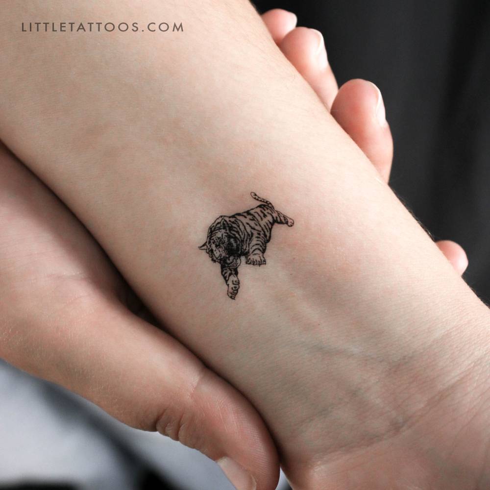 Jumping tiger temporary tattoo located on the wrist.