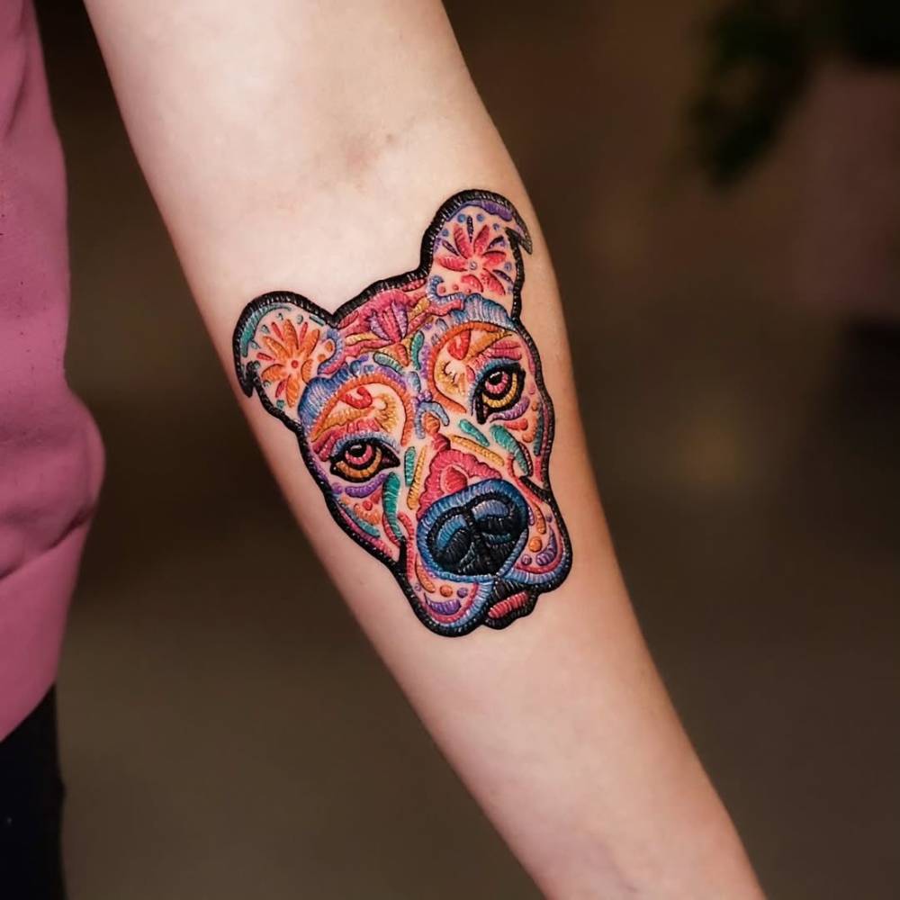 Pit Bull portrait patch tattoo located on the inner forearm.