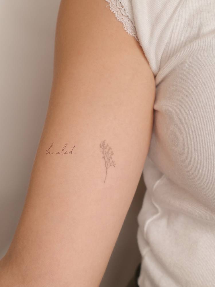 Baby's breath tattoo in fine line style located on the inner arm.