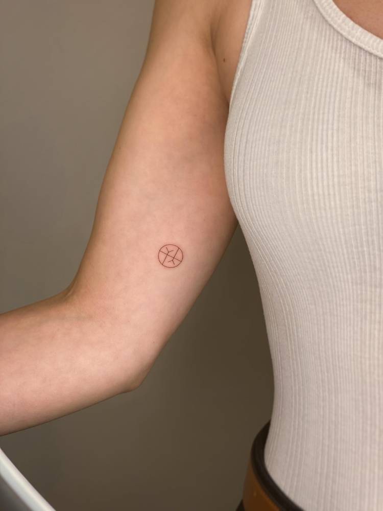 Minimalistic style empathy symbol tattoo placed on the inner arm.