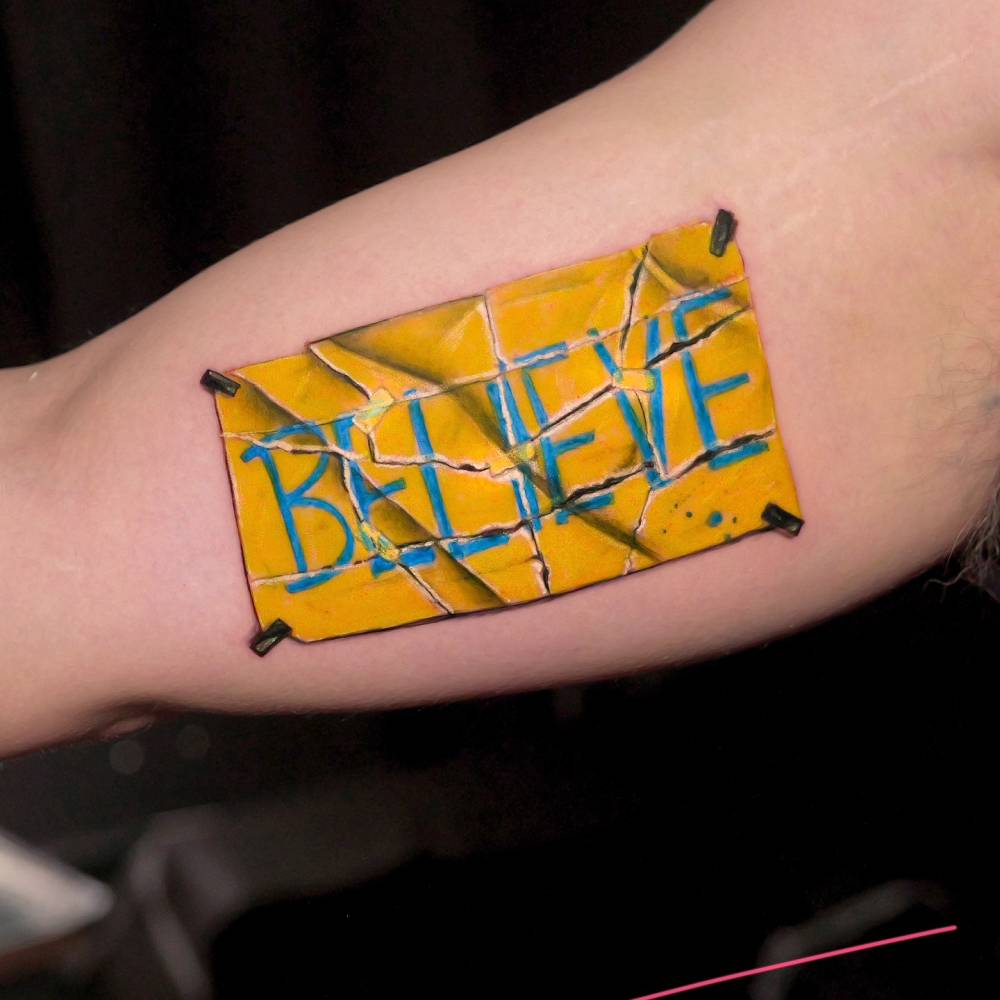 "Believe" from Ted Lasso tattooed on the inner arm.