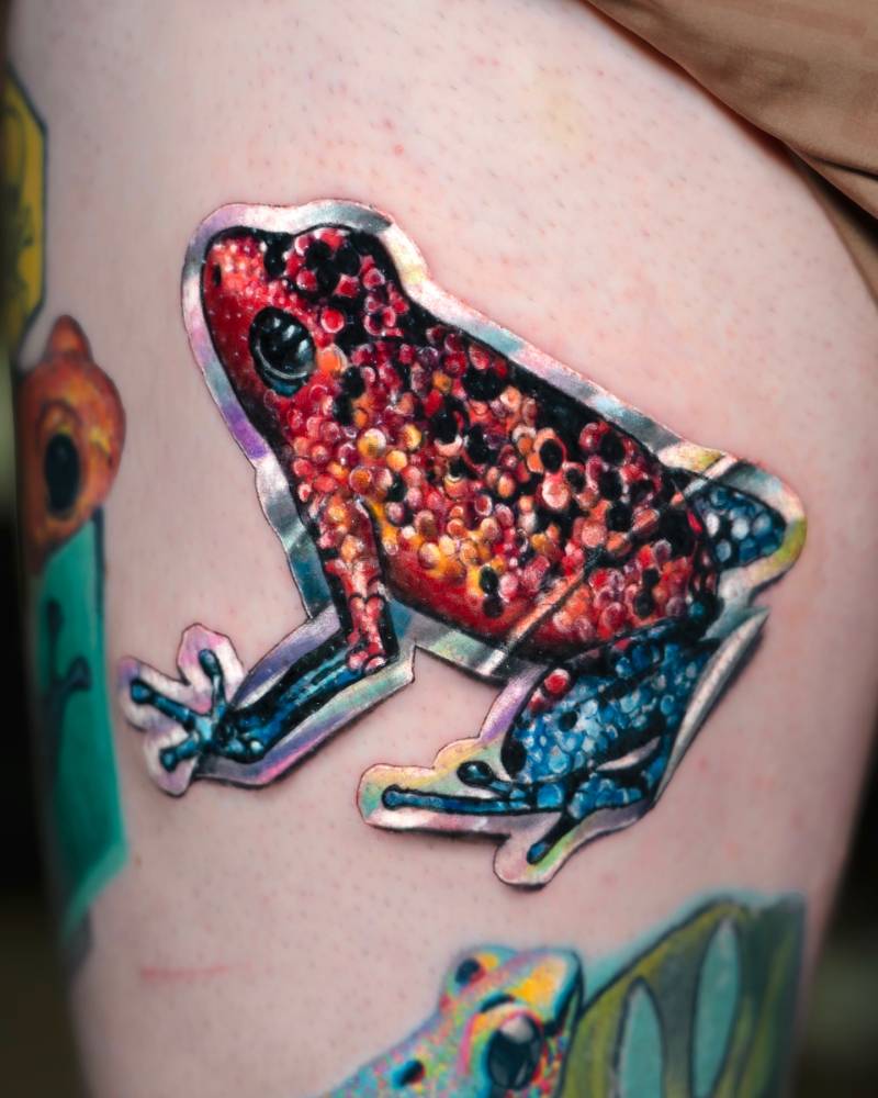 Holographic frog sticker tattoo placed on the thigh.