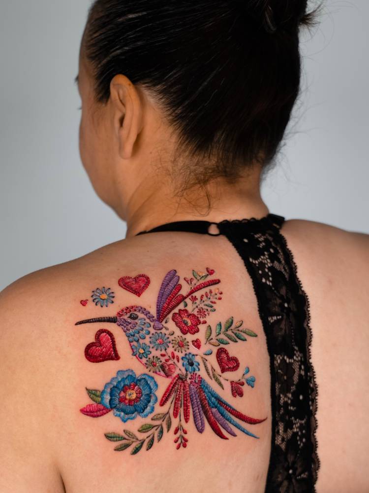 Mexican embroidery hummingbird tattoo located on the shoulder blade.