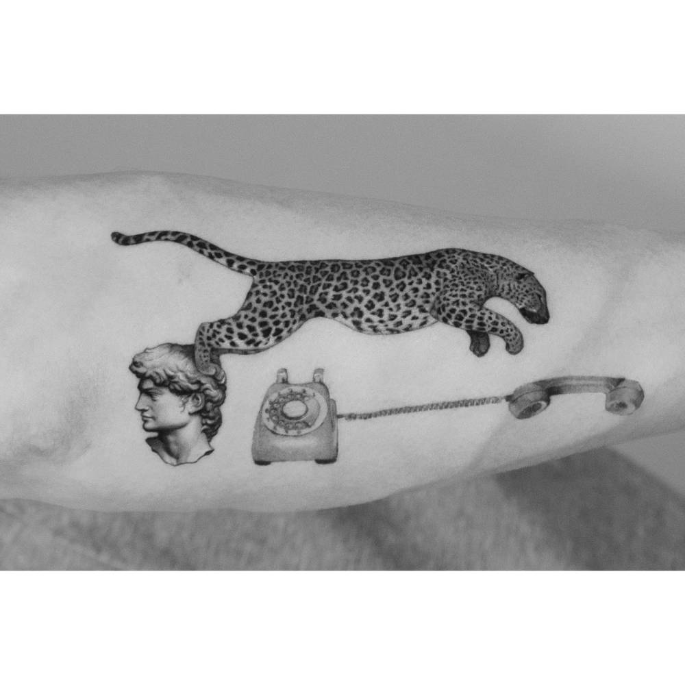 Micro-realistic style leopard, David and telephone tattoo located on the forearm.