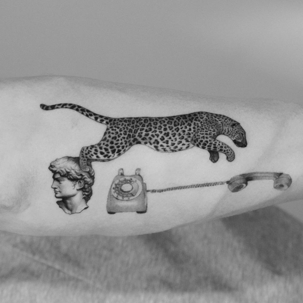Micro-realistic style leopard, David and telephone tattoo located on the forearm.