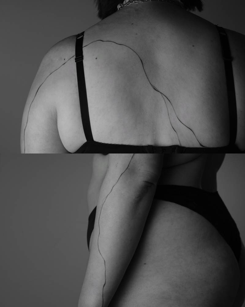 Abstract flowely lines tattooed on the back and forearm.