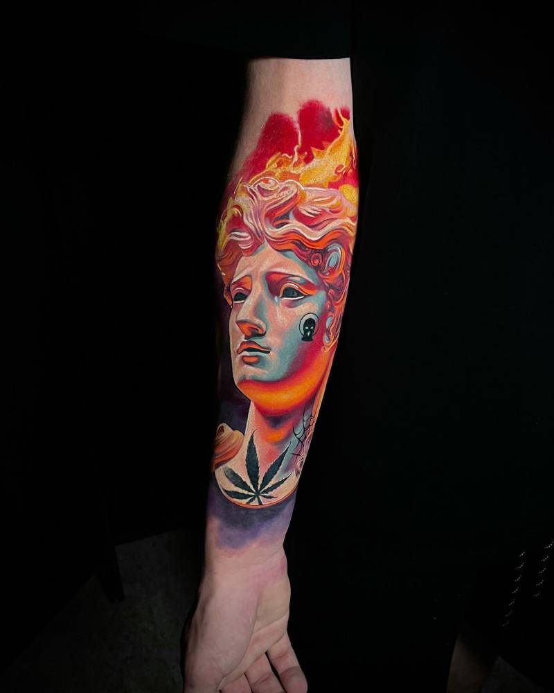 Pop art style Michelangelo's David portrait tattoo located on the inner forearm.