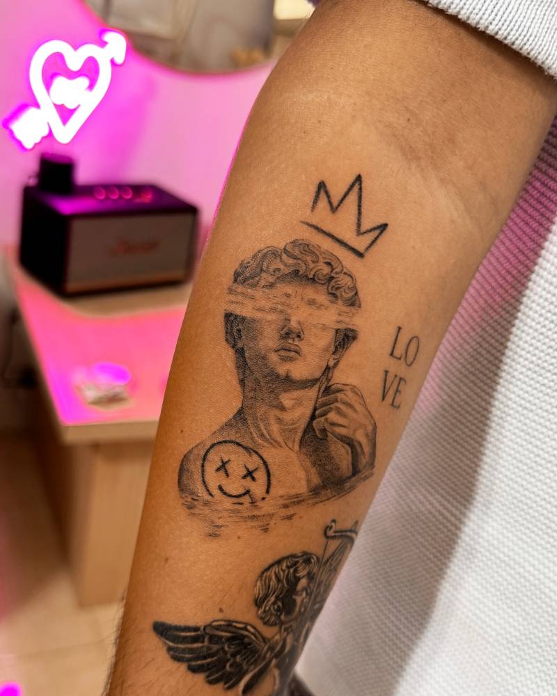 Pop art style Michelangelo's 'David' tattoo located on the inner forearm.