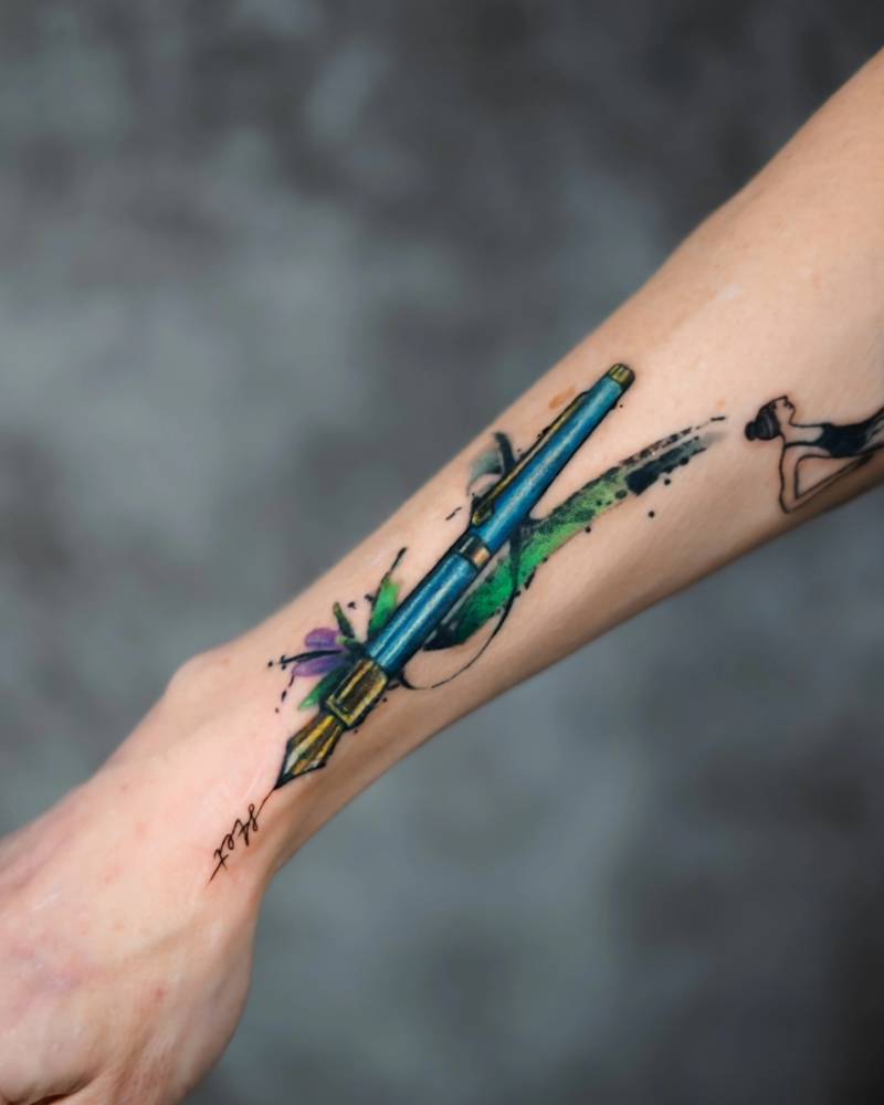 Watercolor style pen tattoo located on the wrist.