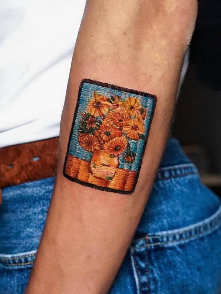 Van Gogh's 'Sunflowers' patch tattoo located on the forearm, embroidery style.