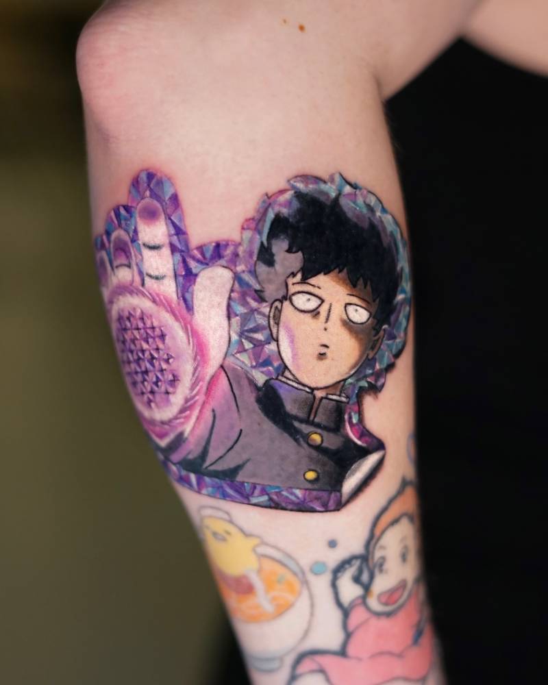 Mob Psycho 100 tattoo located on the forearm, cartoon style.