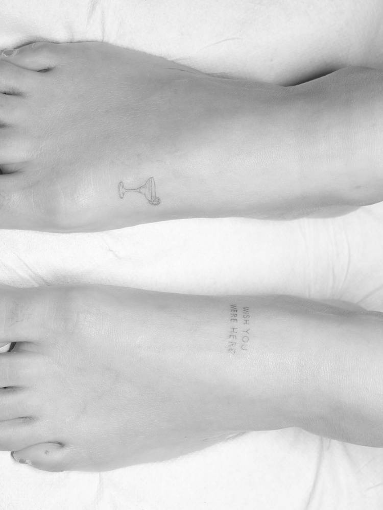 Margarita cocktail and "wish you were here" tattoos located on the feet.